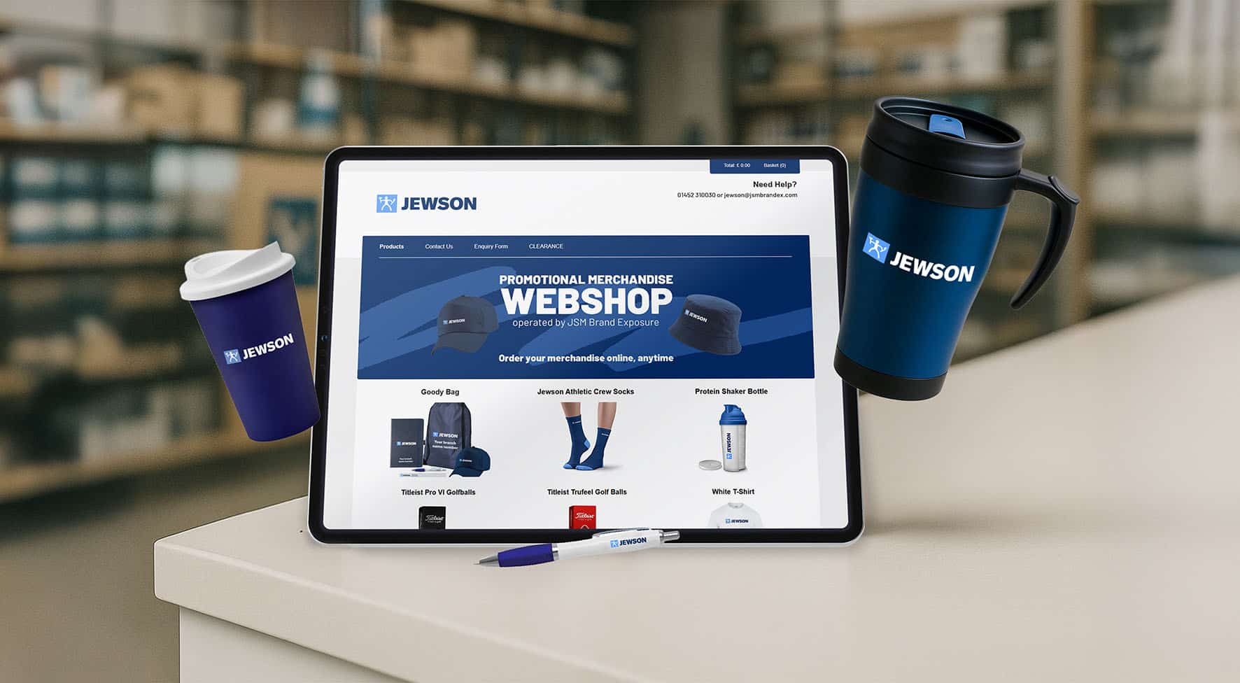 Jewson branded merchandise collection with the corporate webshop on a tablet
