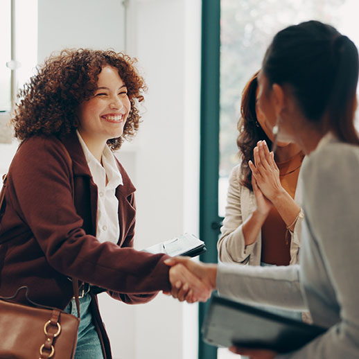 A new JSM team member being welcomed with a handshake