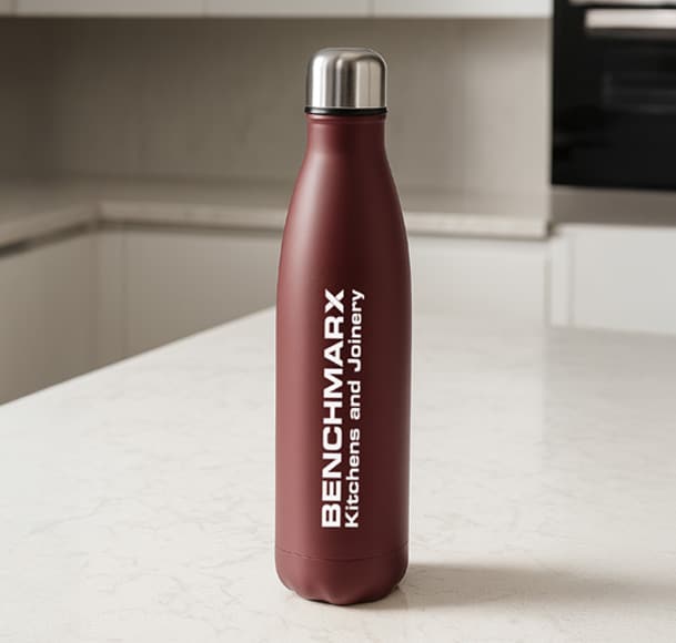 Benchmarx branded thermal bottle on a kitchen counter